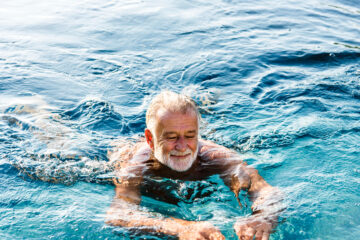 Senior man swimming in pool