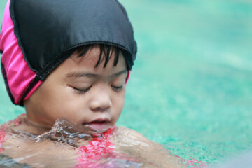 baby girl playing in swimming pool