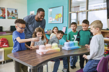 Group of children enjoy science experiment at a YMCA child care center.